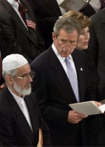 394430 04: US President George W. Bush (C) watches as Muzammil Siddiqi, Imam of the Islamic Society of North America, passes by during a memorial service for victims of the attack on the United States September 14, 2001 in Washington, DC. (Photo by Mark Wilson/Getty Images)